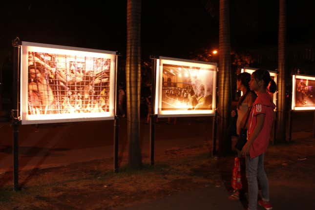People look at a photo exhibit on the drug war at the Redemptorist Church of Baclaran in Manila.