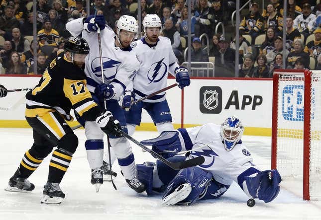Feb 26, 2023; Pittsburgh, Pennsylvania, USA;  Tampa Bay Lightning goaltender Brian Elliott (1) defends against a shot by Pittsburgh Penguins right wing Bryan Rust (17) during the first period at PPG Paints Arena.