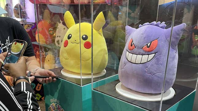 Pikachu and Gengar Squishmallows sit in display cases.