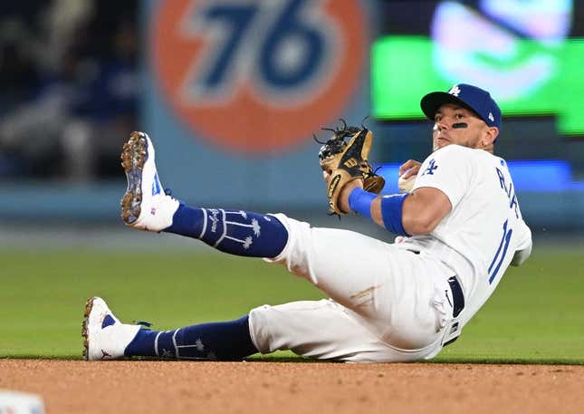 Apr 18, 2023; Los Angeles, California, USA; Los Angeles Dodgers shortstop Miguel Rojas (11) tries to make a play but can   t get New York Mets shortstop Francisco Lindor (12) out at first in the fourth inning at Dodger Stadium.