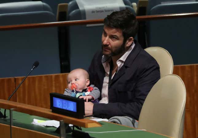 Gayford holds Neve as Ardern speaks.