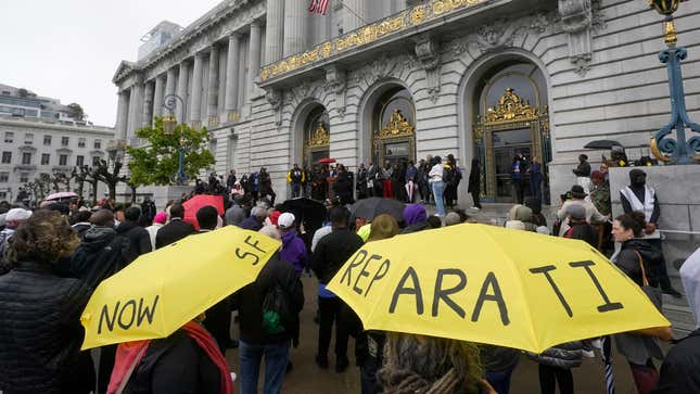 A crowd listens to speakers at a reparations rally outside of City Hall in San Francisco on March 14, 2023. Economists for a California reparations task force estimate the state owes Black residents at least $800 billion for harms in policing, housing and health. 