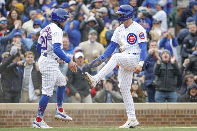 Mar 30, 2023; Chicago, Illinois, USA; Chicago Cubs second baseman Nico Hoerner (2) celebrates with second baseman Miles Mastrobuoni (20) after they both scored against the Milwaukee Brewers during the third inning at Wrigley Field.
