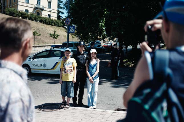Tourists pose for pictures with newly formed Kyiv Police.