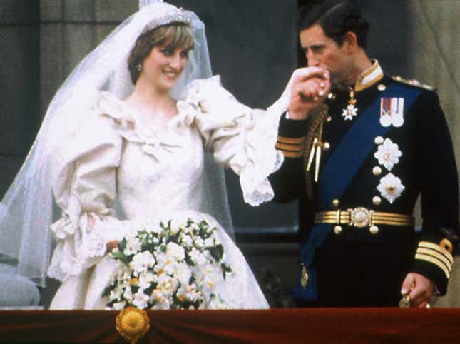 Prince Charles kisses the hand of his bride Princess Diana on the balcony of Buckingham Palace on their wedding day.