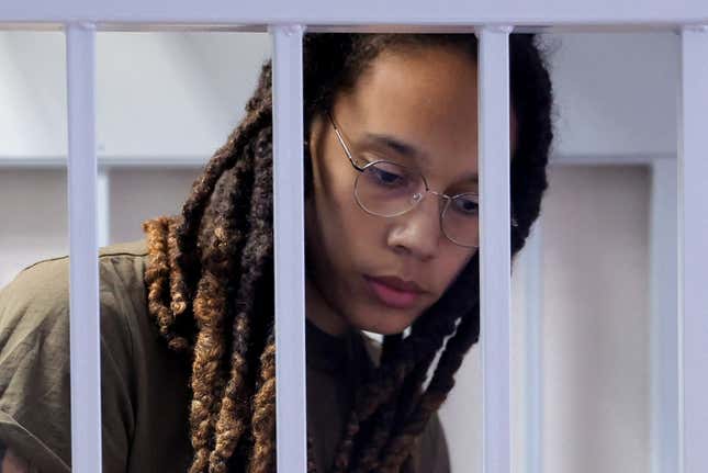 Brittney Griner stands in a defendants’ cage before a court hearing during her trial on charges of drug smuggling, in Khimki, outside Moscow on August 2, 2022. (Photo by EVGENIA NOVOZHENINA / POOL / AFP) (Photo by EVGENIA NOVOZHENINA/POOL/AFP via Getty Images)