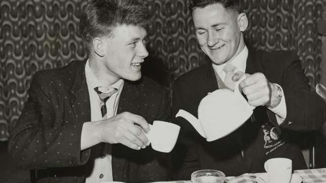 Black and white photo of young men drinking tea