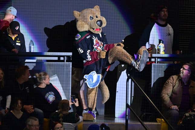 Arizona Coyotes mascot Howler breaks a Vancouver Canucks stick over his leg in the first period at Mullett Arena.