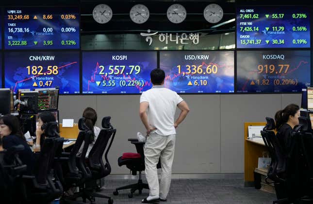 A currency trader watches the screens showing the Korea Composite Stock Price Index (KOSPI), center left, and the foreign exchange rate between U.S. dollar and South Korean won, center right, at the foreign exchange dealing room of the KEB Hana Bank headquarters in Seoul, South Korea, Thursday, Sept. 7, 2023. Shares fell in Asia on Thursday after a decline on Wall Street, where strong economic data revived worries that the Federal Reserve might keep interest rates high for longer than hoped. (AP Photo/Ahn Young-joon)
