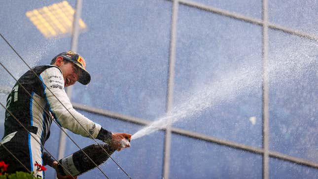 A photo of Esteban Ocon spraying champagne on the podium in 2021. 