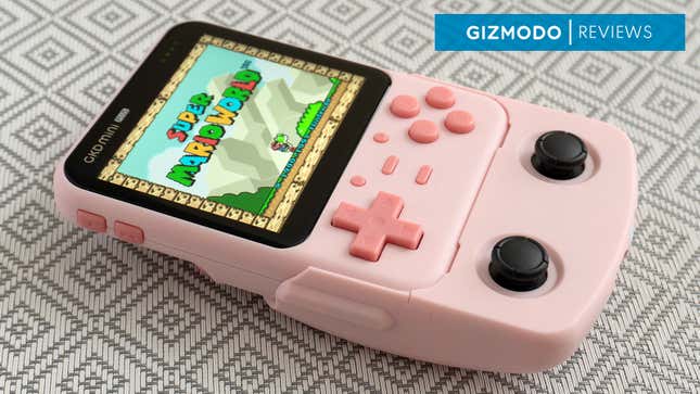 The GDK Mini Plus handheld in pink with the SNES game Super Mario World playing on screen.