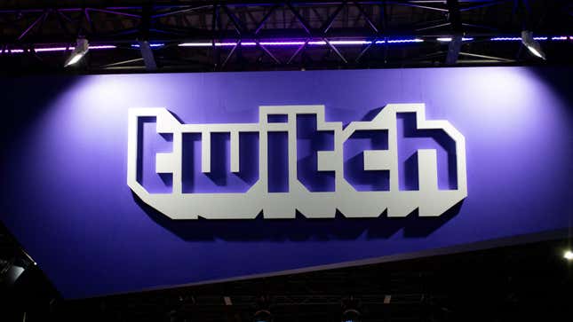 A Twitch banner hangs in a convention hall. 