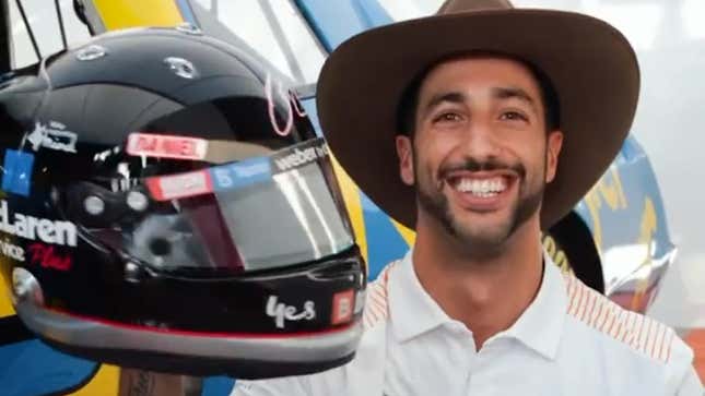 Daniel Ricciardo poses with his new Dale Earnhardt-inspired helmet for the U.S. Grand Prix weekend, in front of one of Earnhardt's cars.