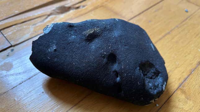 The metallic object believed to be a meteorite on the floor of a home in New Jersey. 