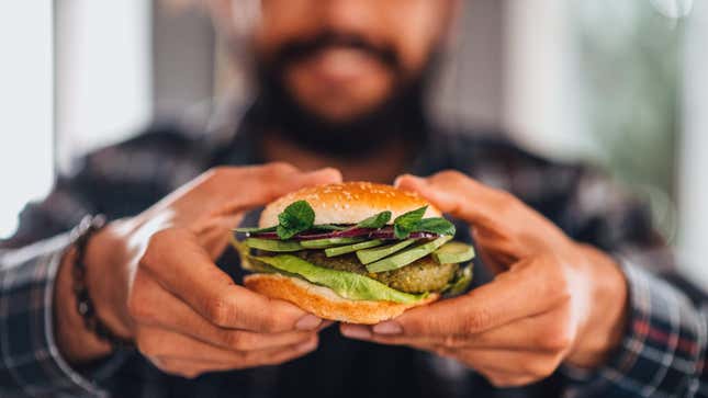 Man holding vegan chickpea burger