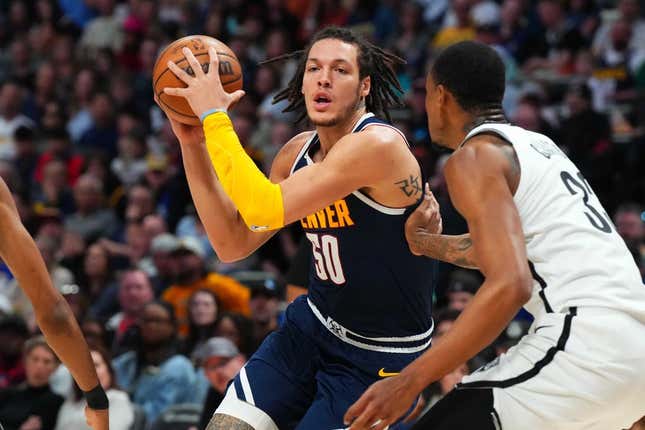 Mar 12, 2023; Denver, Colorado, USA; Denver Nuggets forward Aaron Gordon (50) drives at Brooklyn Nets center Nic Claxton (33) in the second quarter at Ball Arena.