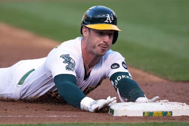 Jun 30, 2023; Oakland, California, USA; Oakland Athletics right fielder Brent Rooker (25) slides into third base for a triple against the Chicago White Sox during the third inning at Oakland-Alameda County Coliseum.