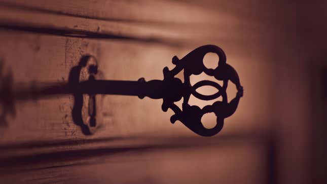 A shadowy key sticks out of an old lock.