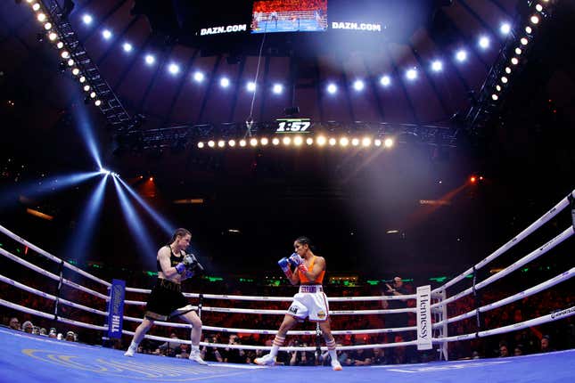 Katie Taylor of Ireland (black trunks) trades punches with Amanda Serrano of Puerto Rico (white trunks) for the World Lightweight Title fight at Madison Square Garden on April 30, 2022 in New York, New York.