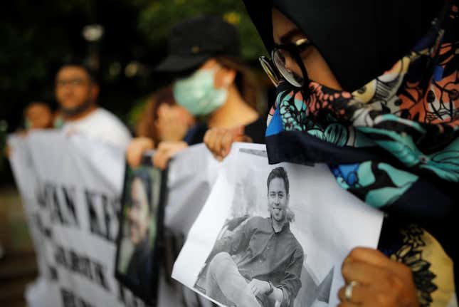 A woman holds a picture of a relative, one of the 189 people killed in a Lion Air plane crash, during a rally calling for Lion Air to put safety over profit and for Indonesian President Joko Widodo to ensure all remains were recovered, in Jakarta, Indonesia December 13, 2018.