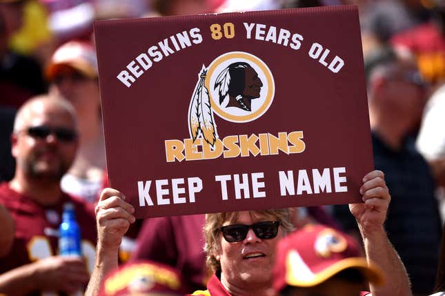 A Washington Redskins fan holds up a sign to keep the Redskins name before they play the Jacksonville Jaguars at FedExField on September 14, 2014 in Landover, Maryland.