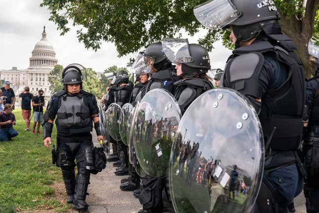 Police in riot gear observe the Justice for J6 rally near the U.S. Capitol in Washington, Saturday, Sept. 18, 2021. The rally was planned by allies of former President Donald Trump and aimed at supporting the so-called “political prisoners” of the Jan. 6 insurrection at the U.S. Capitol.