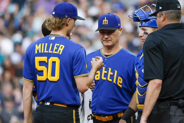 Jun 30, 2023; Seattle, Washington, USA; Seattle Mariners manager Scott Servais (middle) talks with starting pitcher Bryce Miller (50) during a potential injury analysis in the third inning against the Tampa Bay Rays at T-Mobile Park.