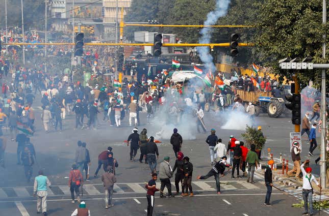 Police use tear gas to disperse the group of farmers.