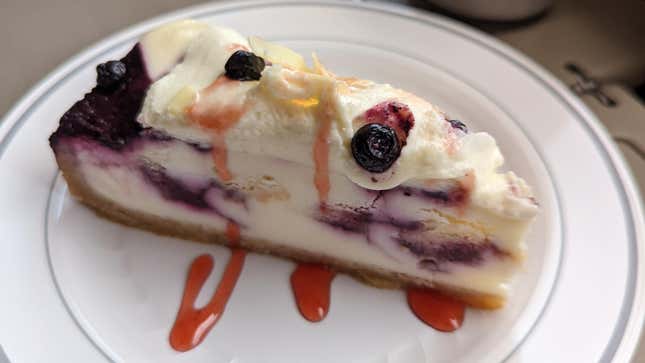 White chocolate blueberry cheesecake with raspberry drizzle