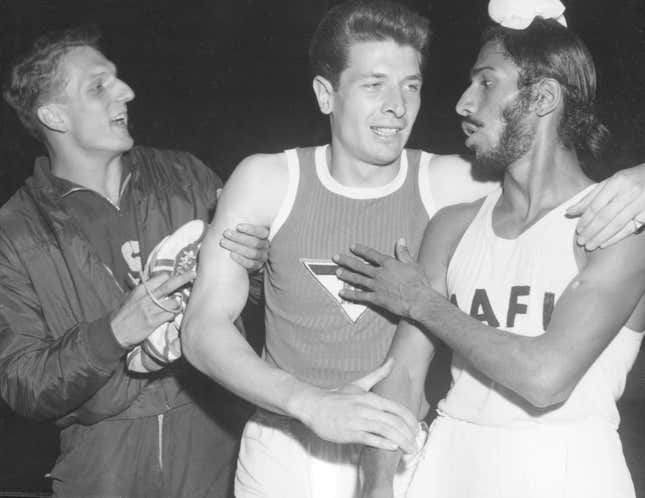 Milkha Singh (r., with German runner Carl Kaufmann, c.) in 1960.