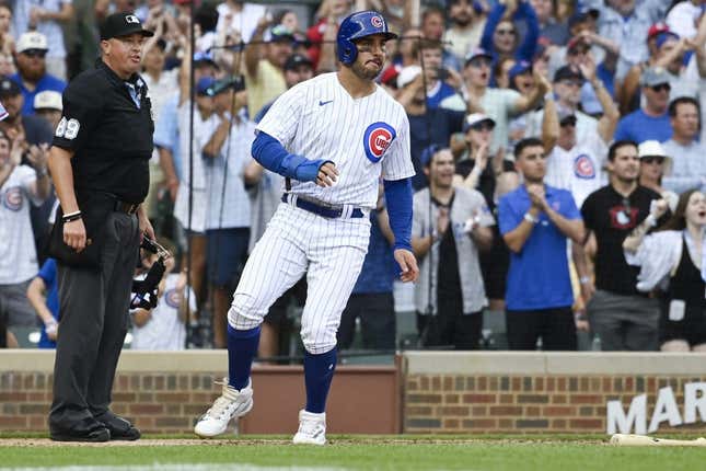 July 22, 2023;  Chicago, Illinois, USA;  Chicago Cubs center fielder Mike Tauchman (40) scores during the sixth inning against the St. Louis Cardinals at Wrigley Field.