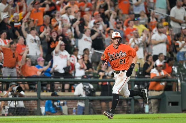 Jul 15, 2023; Baltimore, Maryland, USA;  Baltimore Orioles left fielder Austin Hays (21) scores on right fielder Anthony Santander (not pictured) seventh inning single against the Miami Marlins at Oriole Park at Camden Yards.