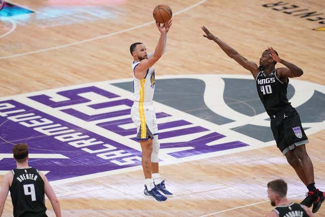 Apr 15, 2023; Sacramento, California, USA; Golden State Warriors guard Stephen Curry (30) makes a three point basket over Sacramento Kings forward Harrison Barnes (40) in the fourth quarter during game one of the 2023 NBA playoffs at the Golden 1 Center.