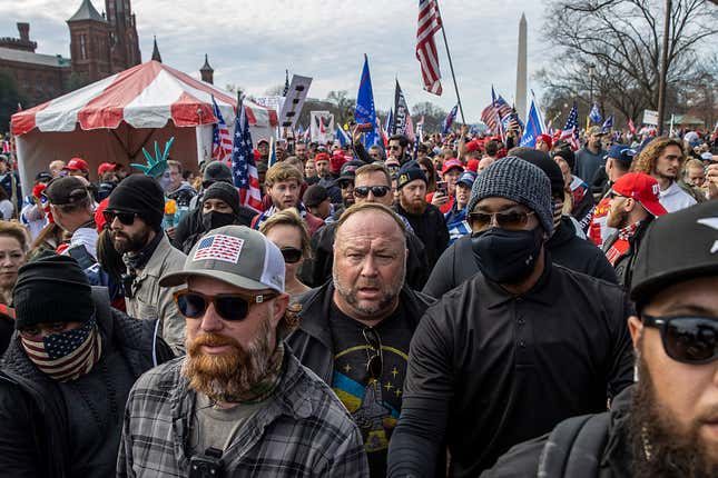 Alex Jones stands in a crowd of Trump protesters during a December, 2020 protest over the election results in Washington D.C.
