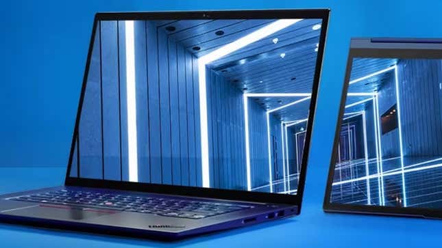 Lenovo laptops on display against a blue backdrop.