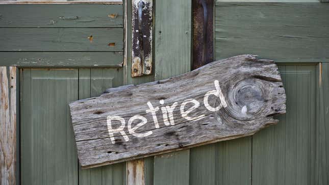 Sign that says "retired" hanging on old green door