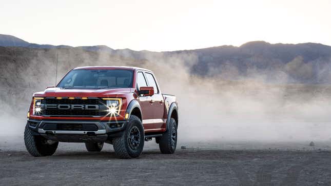 A photo of a red Ford F-150 Raptor pickup. 