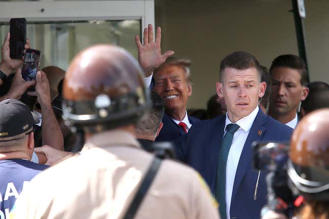Former President Donald Trump waves as he makes a visit to the Cuban restaurant Versailles after he appeared for his arraignment on June 13, 2023 in Miami, Florida.