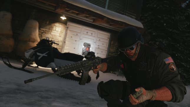 An American soldier in Rainbow Six Siege sets off a detonator and points his gun.