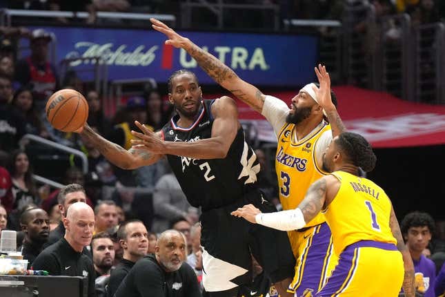 Apr 5, 2023; Los Angeles, California, USA; LA Clippers forward Kawhi Leonard (2) passes the ball against Los Angeles Lakers forward Anthony Davis (3) and guard D&#39;Angelo Russell (1)  in the second half at Crypto.com Arena.