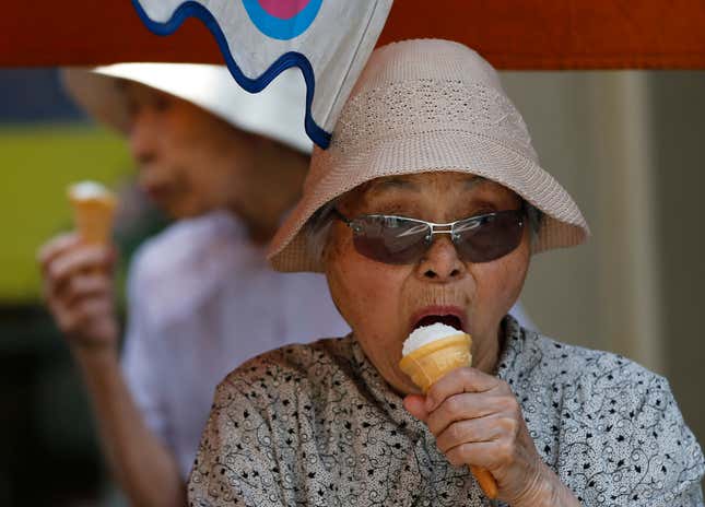 Elderly women eat ice-cream at Tokyo's Sugamo district, an area popular among Japanese elderly, in Tokyo