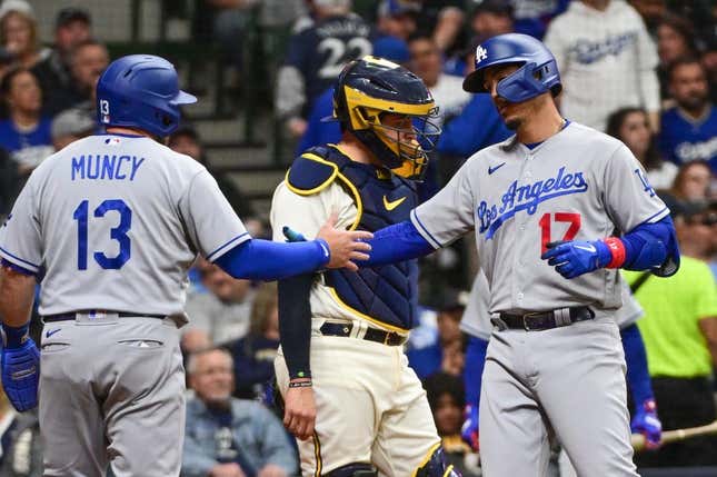 May 9, 2023; Milwaukee, Wisconsin, USA;  Los Angeles Dodgers second baseman Miguel Vargas (17) celebrates with third baseman Max Muncy (13) after hitting a two run home run as Milwaukee Brewers catcher Victor Caratini (7) looks on in the sixth inning at American Family Field.