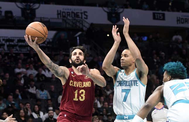 Mar 14, 2023; Charlotte, North Carolina, USA; Cleveland Cavaliers guard Ricky Rubio (13) drives past Charlotte Hornets guard Bryce McGowens (7) during the first half at the Spectrum Center.