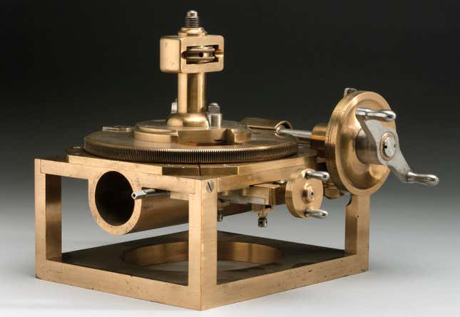 A brass machine with cranks and gears and grooves.