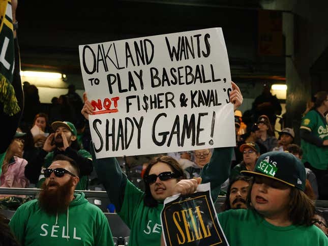 Apr 28, 2023; Oakland, California, USA; An Oakland Athletics fan holds a sign in reference to owner John Fisher and president Dave Kaval (not pictured) during the sixth inning against the Cincinnati Reds at Oakland Coliseum.