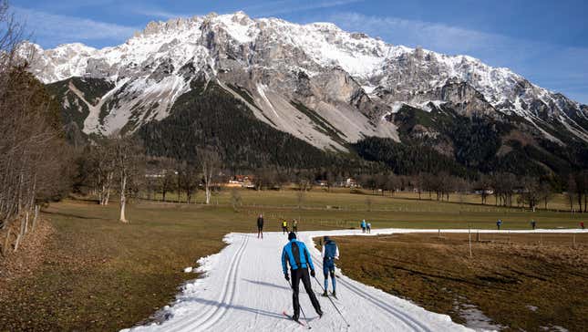 Cross-country skiiers on artificial snow in Ramsau am Dachstein, Austria.