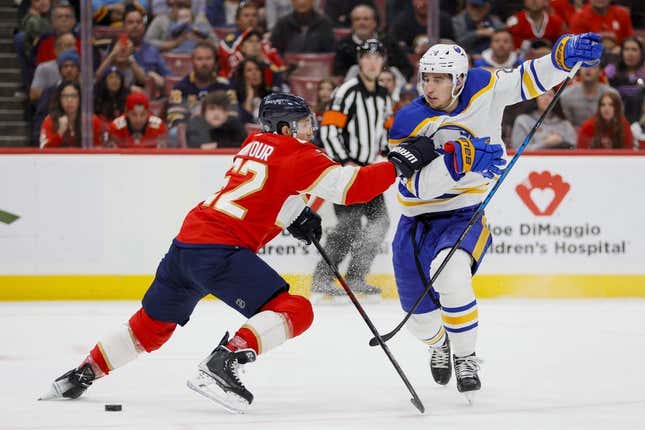 Apr 4, 2023; Sunrise, Florida, USA; Buffalo Sabres center Dylan Cozens (24) attempts to skate past Florida Panthers defenseman Brandon Montour (62) during the first period at FLA Live Arena.