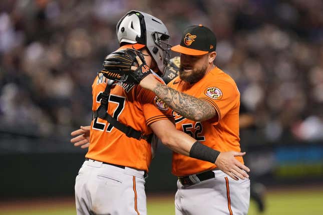 Sep 2, 2023; Phoenix, Arizona, USA; Baltimore Orioles relief pitcher Joey Krehbiel (52) hugs Baltimore Orioles catcher James McCann (27) after defeating the Arizona Diamondbacks at Chase Field.
