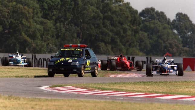 A photo of a Renault Clio safety car leading an F1 race. 