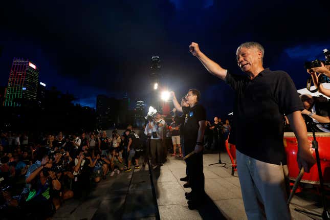 Founders of the Occupy Central civil disobedience movement (R-L) Reverend Chu Yiu-ming, academics Benny Tai and Chan Kin-man chant slogans during a campaign to kick off the movement in front of the financial Central district in Hong Kong August 31, 2014.